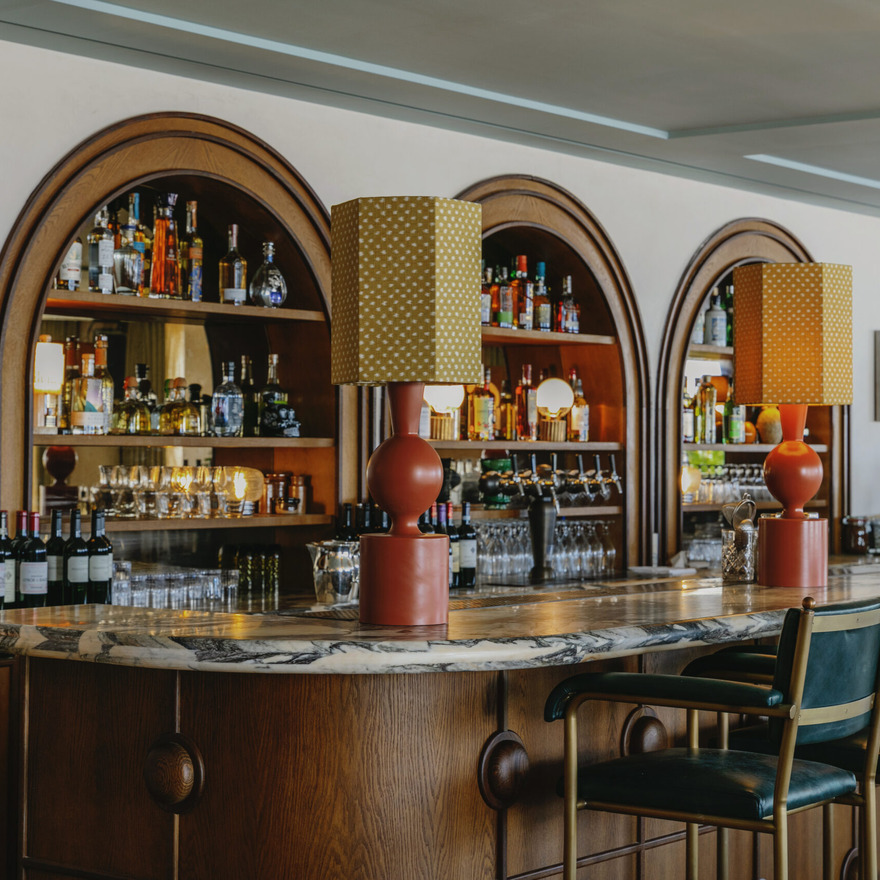 Viero UK's Veneto Venetian plaster on a bar wall, blending warm tones with modern interior elements.